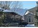 Brick home with mountain views and snow-covered roof at 458 Whitetail Cir, Lafayette, CO 80026