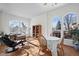 Sunlit living area with hardwood floors and a charming seating arrangement at 458 Whitetail Cir, Lafayette, CO 80026