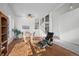 Open living room with hardwood floors, a dining area, and a view of the staircase at 458 Whitetail Cir, Lafayette, CO 80026