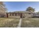 Spacious backyard showcasing the home's brick exterior and access to a sunroom with large windows at 110 E 104Th Pl, Northglenn, CO 80233