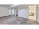 Large basement with neutral carpet, access to stairs, and a bright laundry area at 110 E 104Th Pl, Northglenn, CO 80233