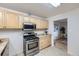 Efficient kitchen featuring stainless steel appliances, wood cabinets, and a view of the living area at 110 E 104Th Pl, Northglenn, CO 80233