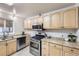 Functional kitchen featuring stainless steel appliances, wood cabinets, and ample counter space at 110 E 104Th Pl, Northglenn, CO 80233