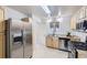 Well-lit kitchen featuring stainless steel appliances, wood cabinets, and a practical layout at 110 E 104Th Pl, Northglenn, CO 80233