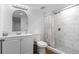 Modern bathroom with stylish vanity, toilet, and tiled shower with glass door, and wood look floors at 12491 E 106Th Pl, Commerce City, CO 80022