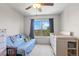 Neutral Bedroom with daybed, crib, and a large window with plenty of natural light at 12491 E 106Th Pl, Commerce City, CO 80022