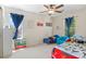 bedroom featuring light gray walls, dark blue curtains, and two beds with a dinosaur theme at 12491 E 106Th Pl, Commerce City, CO 80022