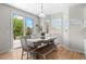 Bright dining area with bench seating and sliding glass door to outdoor deck area at 12491 E 106Th Pl, Commerce City, CO 80022
