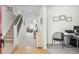 Bright entryway featuring hardwood floors, a staircase, and a view into the living room, creating an inviting atmosphere at 12491 E 106Th Pl, Commerce City, CO 80022