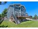 Charming home exterior highlighting a spacious deck with stairs and well-manicured lawn on a sunny day at 12491 E 106Th Pl, Commerce City, CO 80022