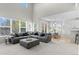 Bright and open living space with large windows, comfortable seating, and views of the kitchen and dining area at 12491 E 106Th Pl, Commerce City, CO 80022
