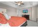 Spacious main bedroom features a ceiling fan and a tv on the wall above a wooden dresser at 12491 E 106Th Pl, Commerce City, CO 80022