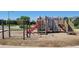 Community playground features a castle themed play structure with slides and climbing bars at 12491 E 106Th Pl, Commerce City, CO 80022