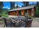 Charming backyard featuring a patio set, pond, and beautiful landscaping, perfect for outdoor entertaining at 1345 Witter Gulch Rd, Evergreen, CO 80439