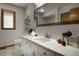 Bright bathroom features a large mirror, vanity with storage, and modern fixtures at 1345 Witter Gulch Rd, Evergreen, CO 80439
