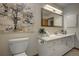 Bathroom featuring a vanity with storage, a large mirror, and modern fixtures at 1345 Witter Gulch Rd, Evergreen, CO 80439