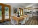 Open dining area with french doors, views, and white wood dining chairs at 1345 Witter Gulch Rd, Evergreen, CO 80439