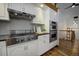 Bright kitchen with white cabinets, stainless steel appliances, and granite countertops at 1345 Witter Gulch Rd, Evergreen, CO 80439