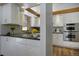 Bright kitchen featuring white cabinets, granite counters, and stainless appliances at 1345 Witter Gulch Rd, Evergreen, CO 80439