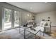 Bright living room with French doors, comfortable armchairs, and stylish coffee tables for an inviting atmosphere at 1345 Witter Gulch Rd, Evergreen, CO 80439