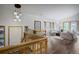 View from stairs of inviting living room with large windows and comfortable seating at 1345 Witter Gulch Rd, Evergreen, CO 80439