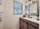 Updated bathroom with a farmhouse-style vanity and tiled shower at 5285 Gladiola St, Arvada, CO 80002