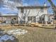 Back exterior view of house showcasing a large deck and landscaped yard at 5285 Gladiola St, Arvada, CO 80002