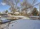 View of the house from the driveway, showcasing the backyard and landscaping at 5285 Gladiola St, Arvada, CO 80002