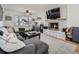 Living room with a fireplace, built-ins, and a large sectional sofa at 5285 Gladiola St, Arvada, CO 80002