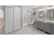 Modern bathroom with double sinks, a walk-in shower with a glass door and sliding door closet at 199 Simmental Loop, Castle Rock, CO 80104