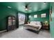 Bright bedroom boasts a large window, ceiling fan, and sleek metal bed frame for a modern touch at 199 Simmental Loop, Castle Rock, CO 80104