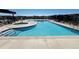 Refreshing community pool with a spa, sun loungers, and clear blue water for residents to enjoy at 199 Simmental Loop, Castle Rock, CO 80104