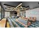 Modern game room featuring a foosball table, neon sign, comfortable seating, and sleek decor at 199 Simmental Loop, Castle Rock, CO 80104