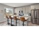 Charming kitchen with stainless steel appliances, tiled backsplash, and breakfast bar seating at 199 Simmental Loop, Castle Rock, CO 80104