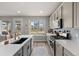 Bright kitchen with stainless appliances, stone countertops, and a view of the neighborhood at 199 Simmental Loop, Castle Rock, CO 80104