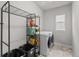 Functional laundry room with modern washer/dryer, storage shelves, and ample space for laundry tasks at 199 Simmental Loop, Castle Rock, CO 80104