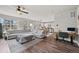 Open-concept living room with hardwood floors, views of dining area, and comfortable sectional at 199 Simmental Loop, Castle Rock, CO 80104