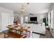 Open-concept living room featuring hardwood floors, living room, and a dining table at 199 Simmental Loop, Castle Rock, CO 80104