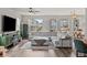 Spacious living room with hardwood floors, large windows, and comfortable sectional sofa at 199 Simmental Loop, Castle Rock, CO 80104