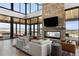 Stylish resident lounge featuring a stone fireplace, expansive windows, and comfortable seating areas at 199 Simmental Loop, Castle Rock, CO 80104