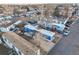 Aerial view of a mobile home community featuring a mix of colorful homes and mature trees at 1500 W Thornton Pkwy # 163, Thornton, CO 80260