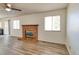 Living room featuring a brick fireplace, ceiling fan and hardwood flooring at 1167 S Ceylon St, Aurora, CO 80017