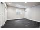 Basement features black rubber flooring, a window, and bright white walls, along with a conveniently located closet and door at 1215 S Ogden St, Denver, CO 80210