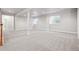 Spacious basement area featuring neutral carpeting, bright windows, and a support beam, providing ample natural light at 1215 S Ogden St, Denver, CO 80210
