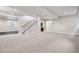 Bright and open basement featuring recessed lighting, neutral carpeting, and a convenient staircase leading to the upper levels at 1215 S Ogden St, Denver, CO 80210
