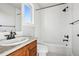 Bathroom features granite countertops, cherry wood vanity, and tiled shower and walls at 1215 S Ogden St, Denver, CO 80210