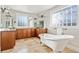 Elegant bathroom with a freestanding tub, natural stone floors, and lots of counter space at 1215 S Ogden St, Denver, CO 80210