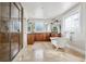 Bright bathroom with a glass shower, soaking tub, dual sinks, and stylish vanity at 1215 S Ogden St, Denver, CO 80210