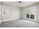 The neutral bedroom with a large window and access to an outdoor balcony for enjoying fresh air at 1215 S Ogden St, Denver, CO 80210