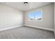 Bright bedroom with a large window and neutral carpet, providing a cozy and inviting space at 1215 S Ogden St, Denver, CO 80210